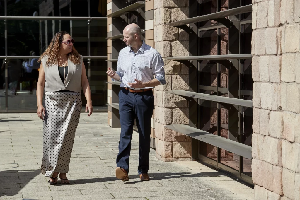 Data consultant walking and talking with a client during a data warehouse project engagement