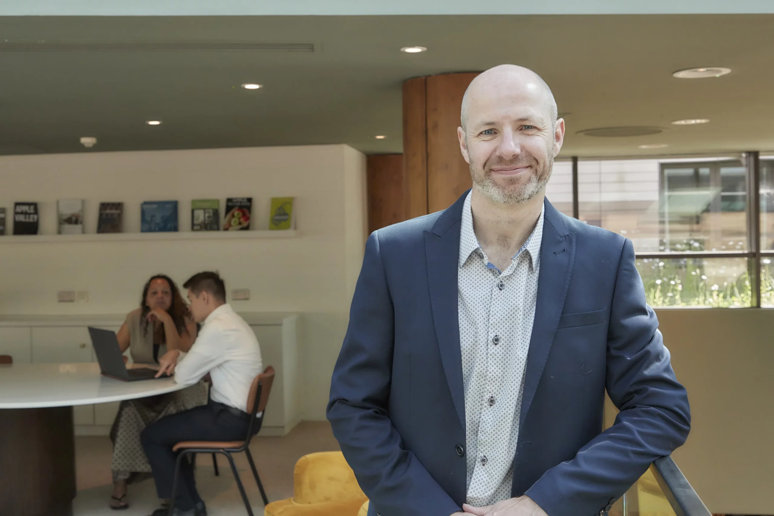 David Laws, fractional head of data, in a co-working environment with team in background