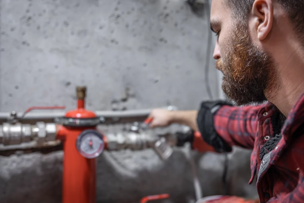 Field service engineer reading a pressure gauge during a maintenance check