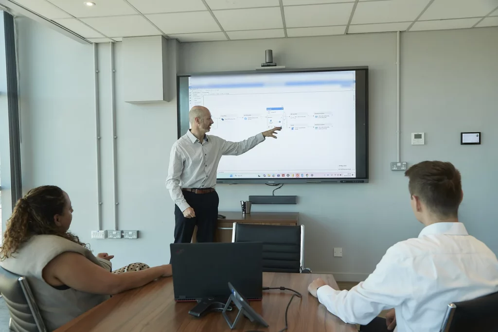 David Laws walking a client team through a data pipeline on a large screen